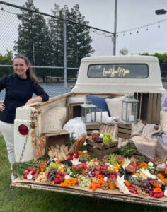 Private Chef Audrey Aparicio next to a grazing board she created (a whole new meaning of Food Truck!)